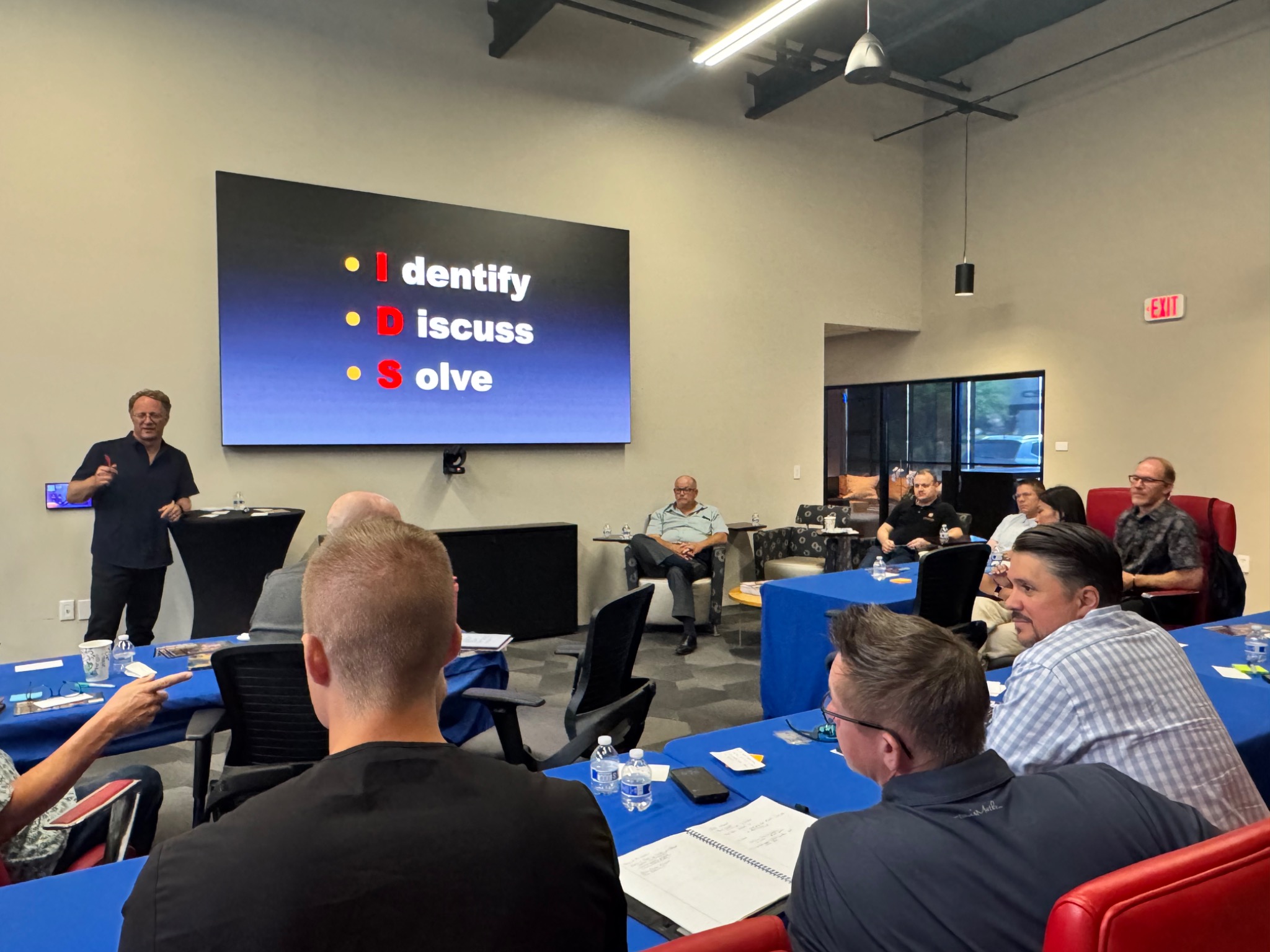 Rick Benton facilitating an ENRG discussion with Identify, Discuss, Solve on screen